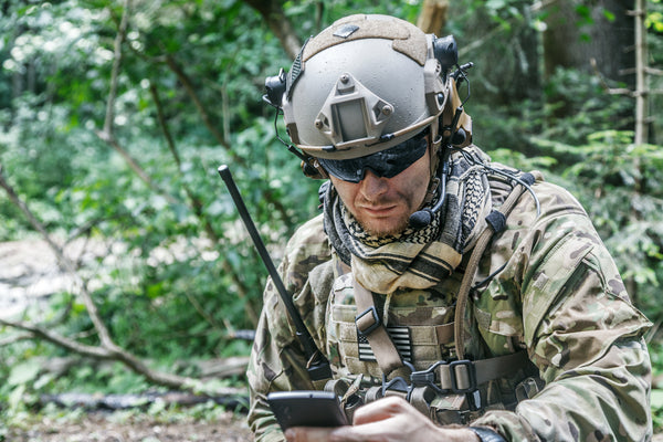 Image of soldier in wilderness on comms.